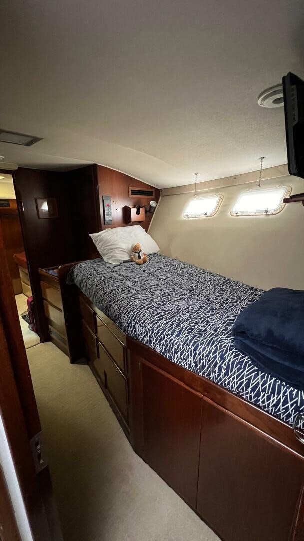 a bedroom with a bed and a desk aboard SEA OWL Yacht for Sale
