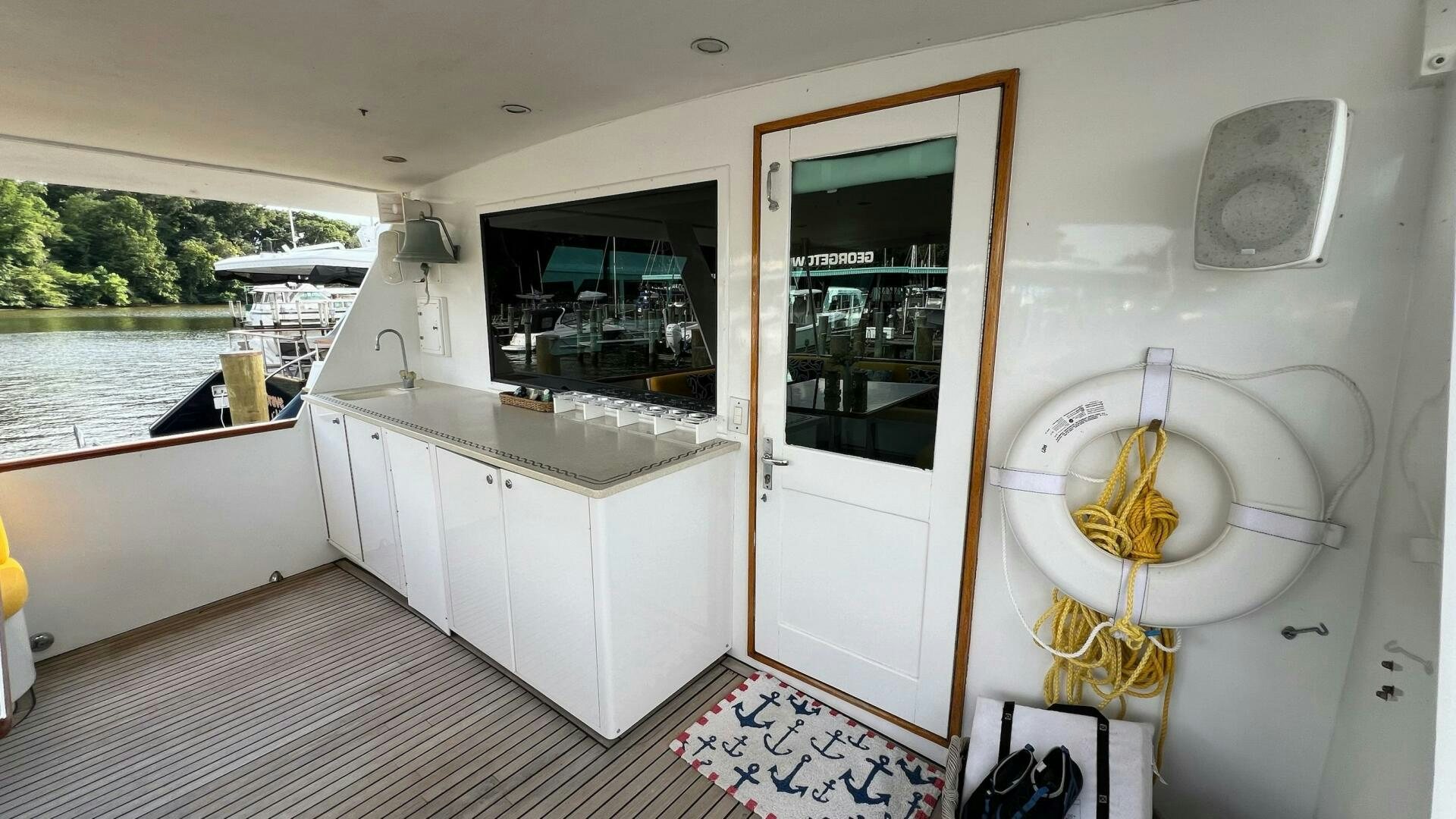 a white kitchen with a large window aboard SEA OWL Yacht for Sale