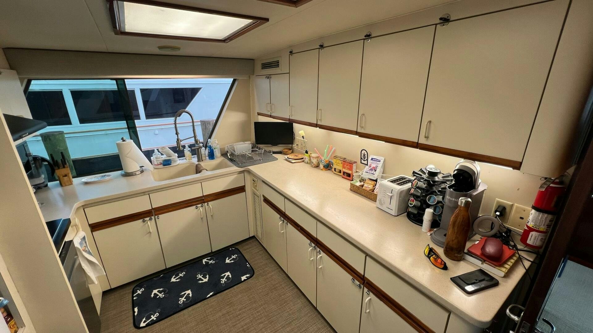 a kitchen with white cabinets aboard SEA OWL Yacht for Sale