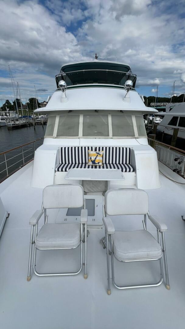 a white boat with chairs on the deck aboard SEA OWL Yacht for Sale
