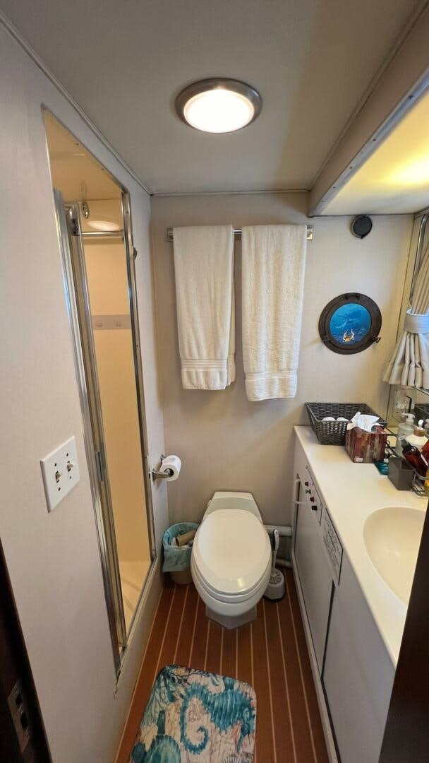 a bathroom with a toilet and a sink aboard SEA OWL Yacht for Sale