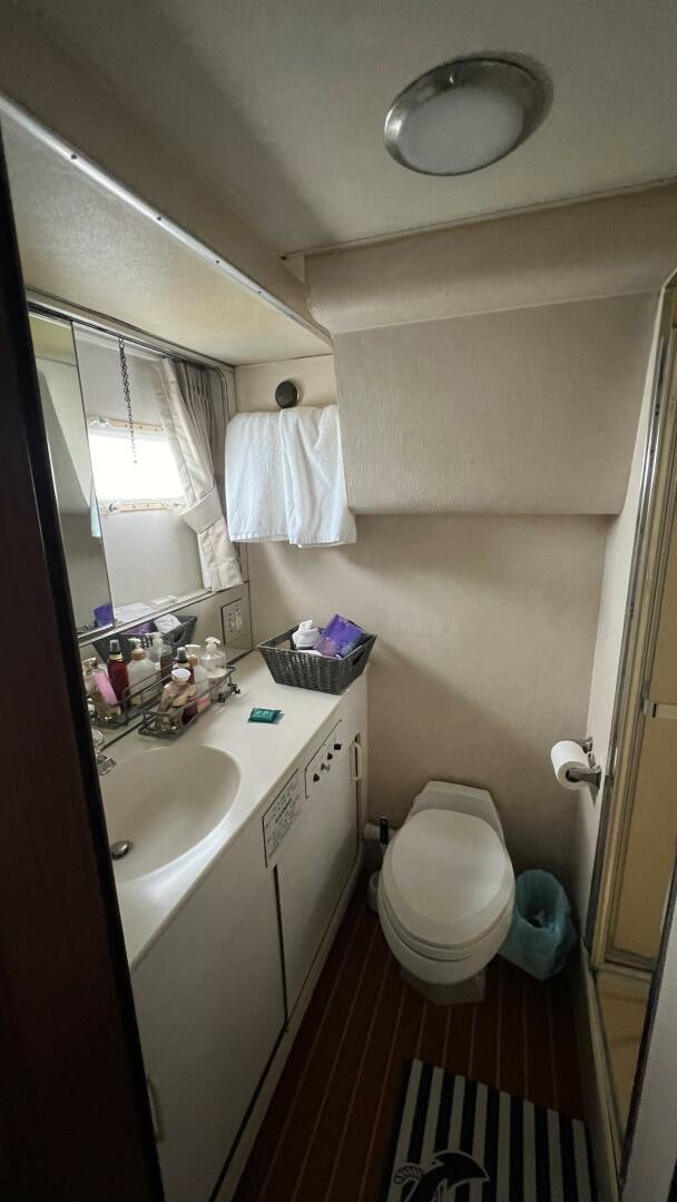 a bathroom with a toilet sink and a mirror aboard SEA OWL Yacht for Sale