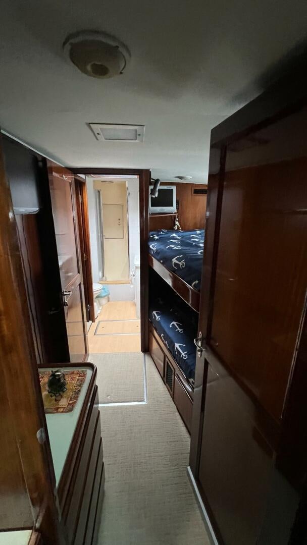 a hallway with a door and cabinets aboard SEA OWL Yacht for Sale