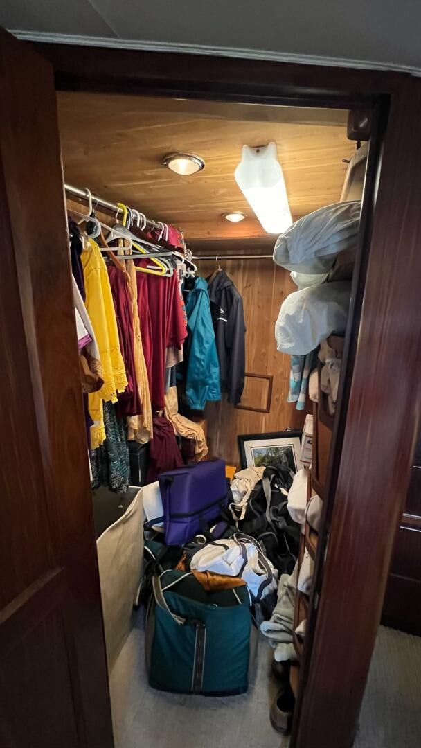 a closet full of clothes aboard SEA OWL Yacht for Sale