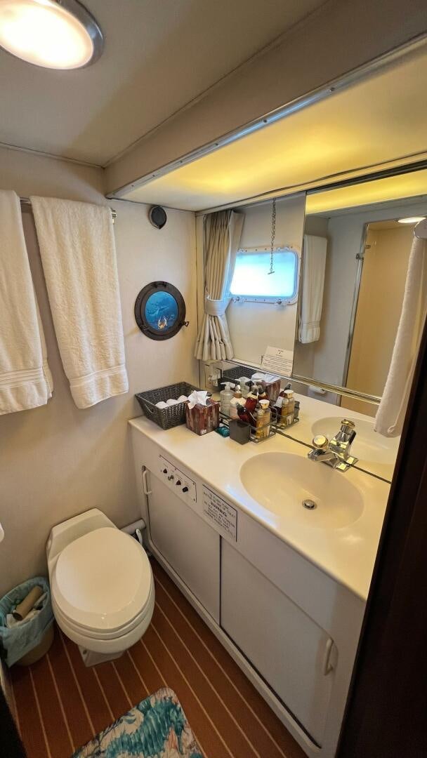 a bathroom with a toilet and sink aboard SEA OWL Yacht for Sale