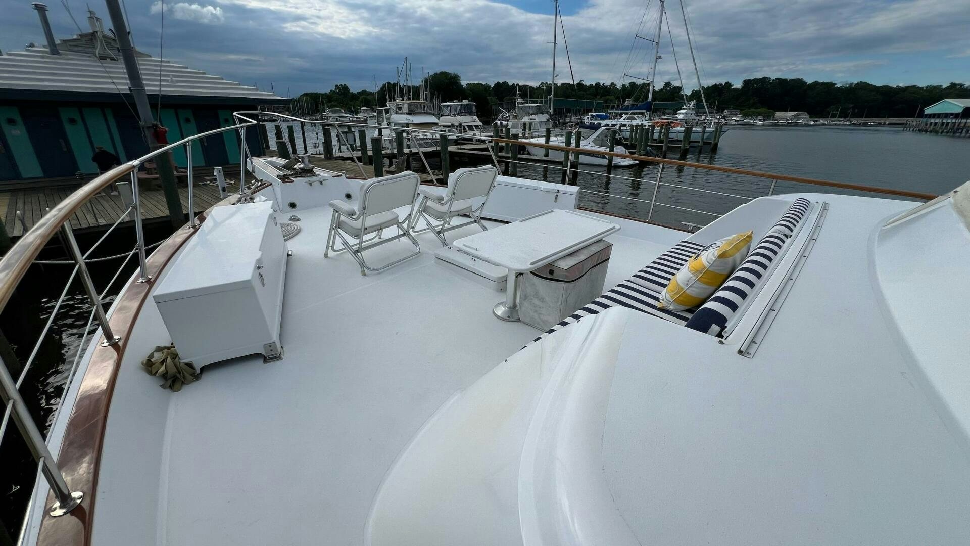 a rooftop deck with a table and chairs on it aboard SEA OWL Yacht for Sale