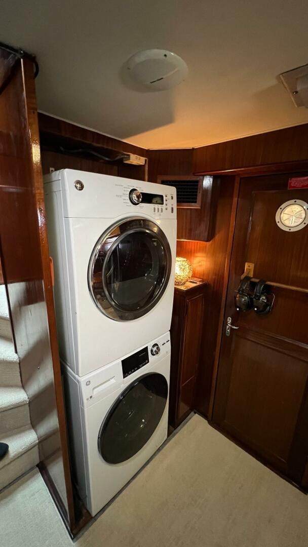 a washer and dryer in a room aboard SEA OWL Yacht for Sale