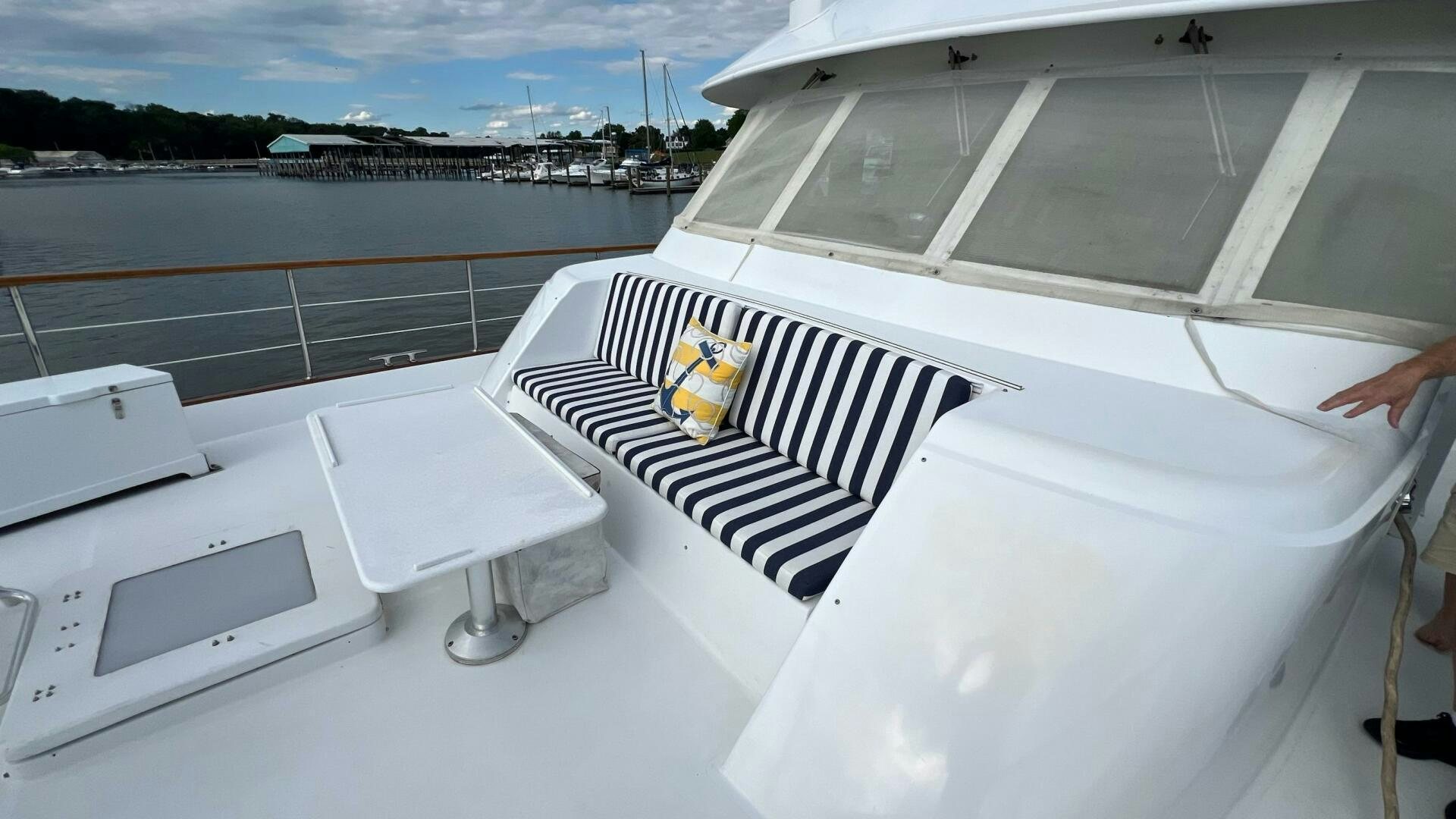 a white car with a black and white stripe on the front aboard SEA OWL Yacht for Sale