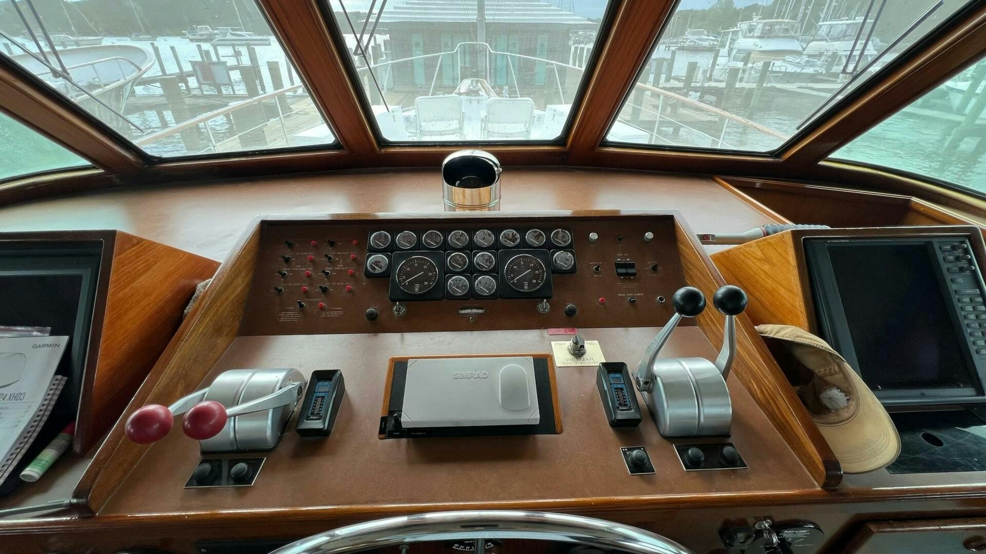 a wooden desk with a computer and other electronics on it aboard SEA OWL Yacht for Sale