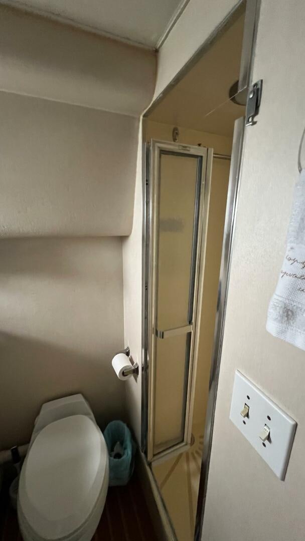 a bathroom with a toilet and a door aboard SEA OWL Yacht for Sale