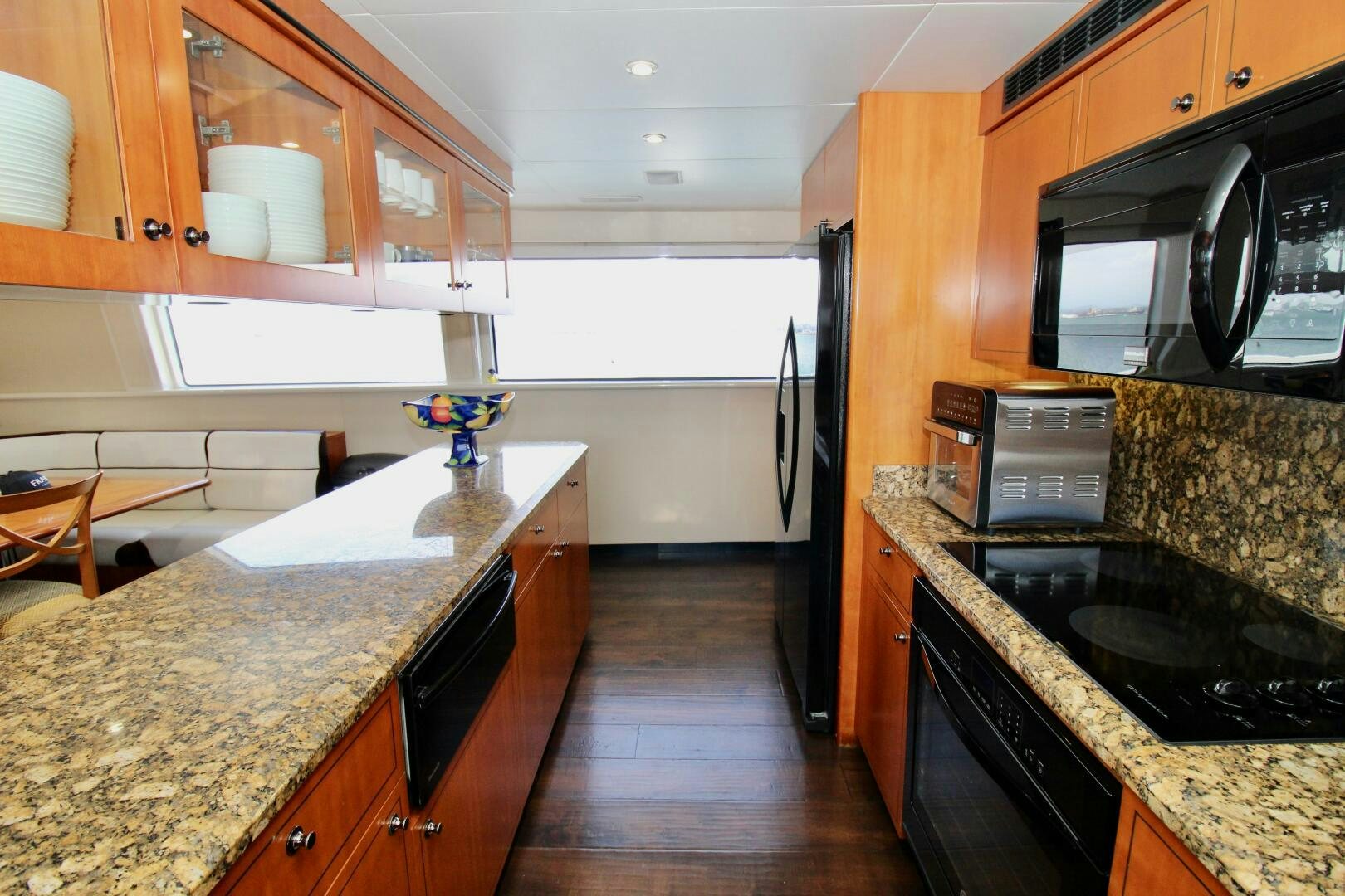 a kitchen with black appliances aboard MY WAY Yacht for Sale