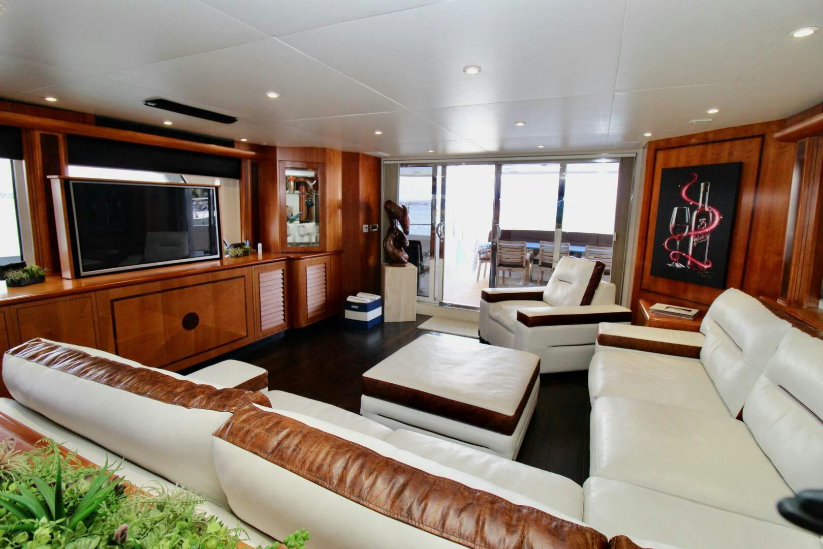 a living room with a tv and couches aboard MY WAY Yacht for Sale