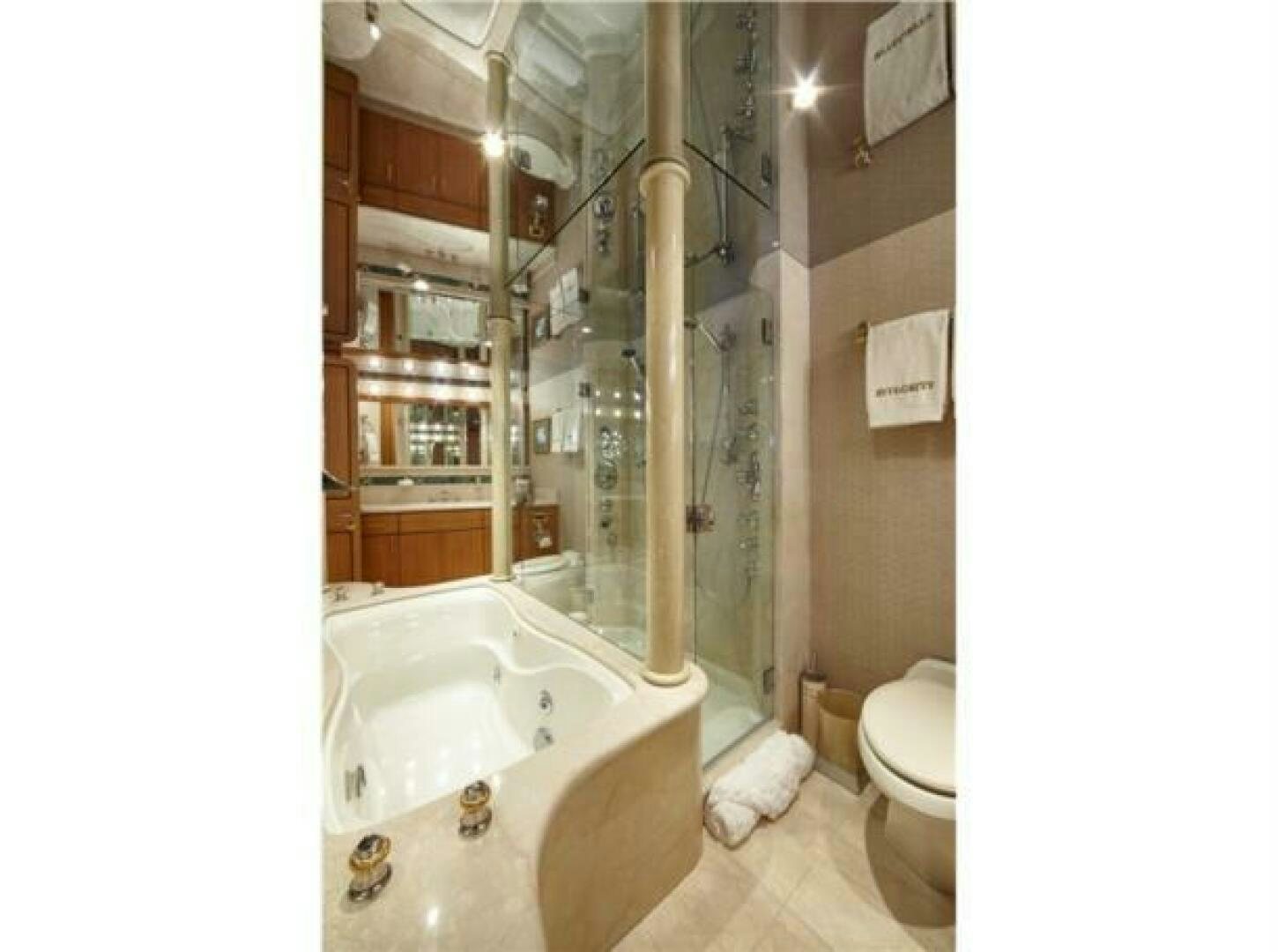 a bathroom with a tub and shower aboard INTEGRITY Yacht for Sale