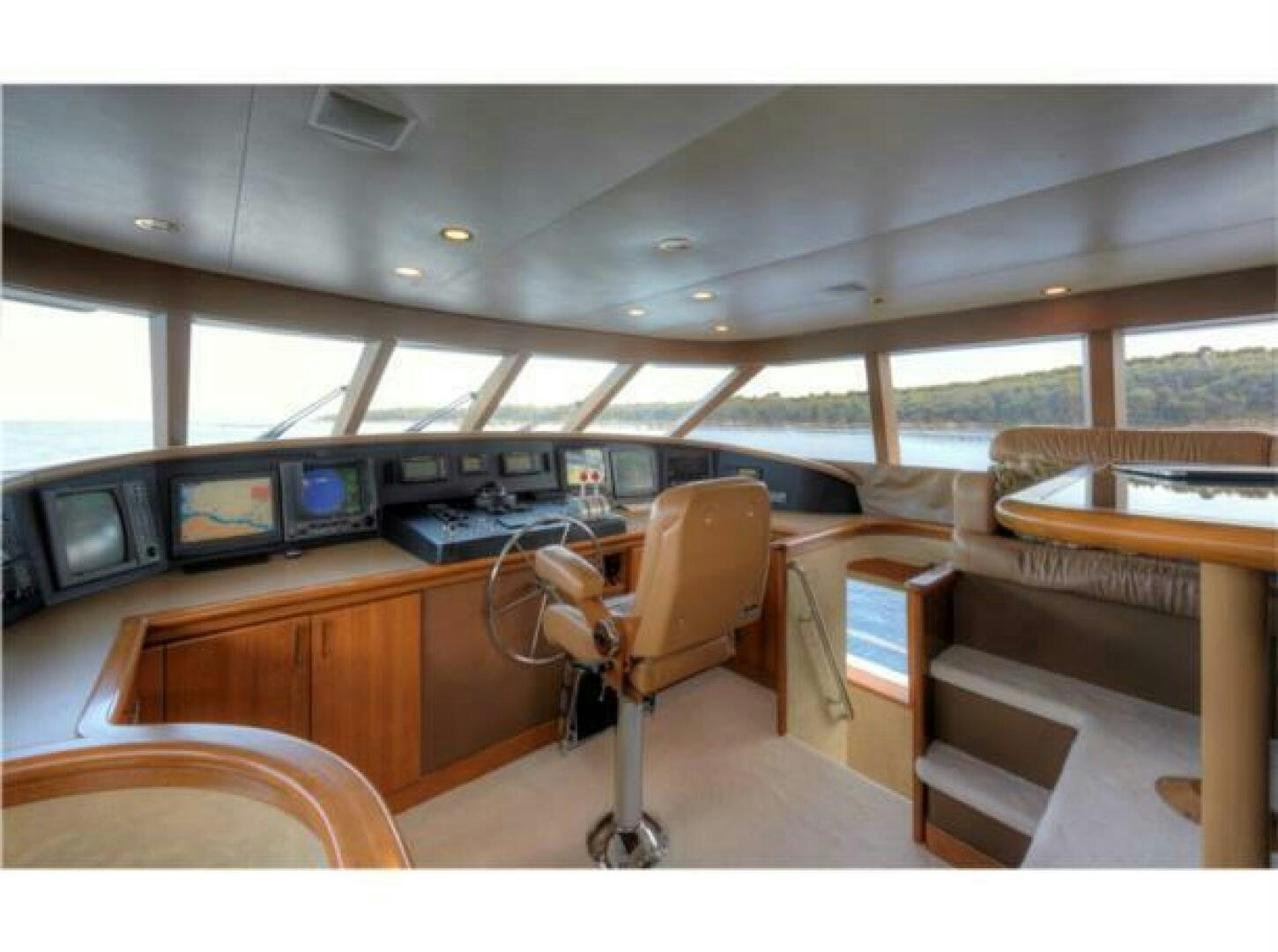 a room with a chair and a desk with a large window aboard INTEGRITY Yacht for Sale