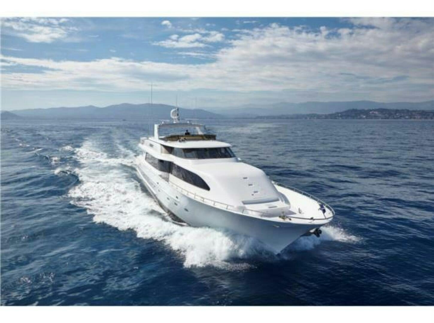 a white yacht on the water aboard INTEGRITY Yacht for Sale