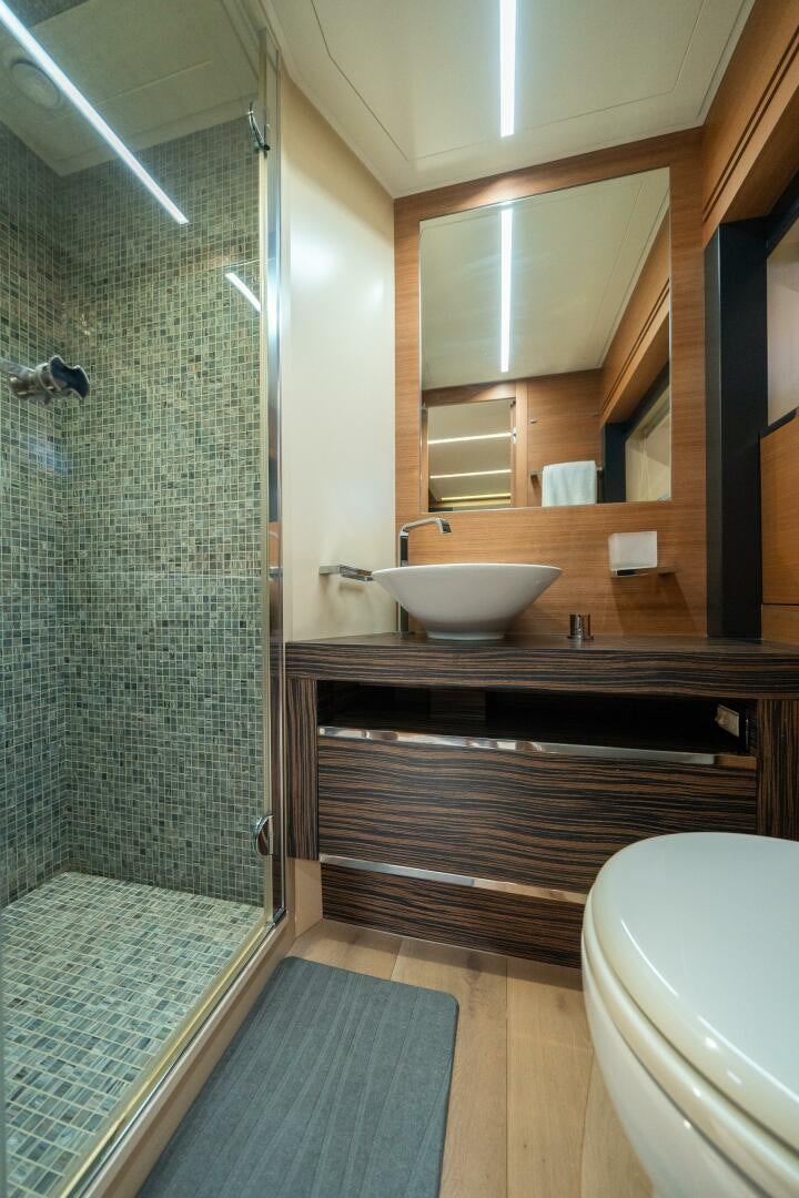 a bathroom with a glass shower aboard INCOGNITO Yacht for Sale