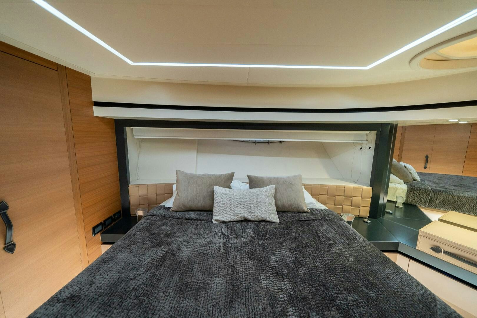 a bed with a black comforter aboard INCOGNITO Yacht for Sale