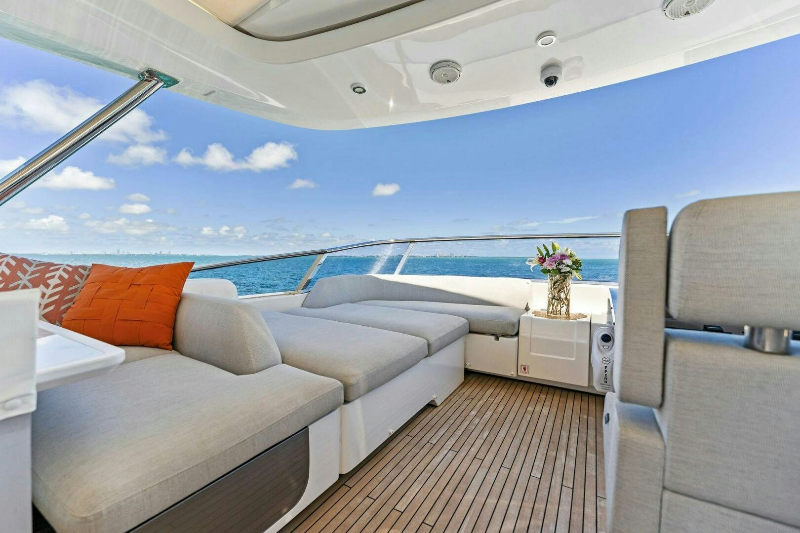 a boat with a sofa and a table on the deck aboard LIMITLESS Yacht for Sale