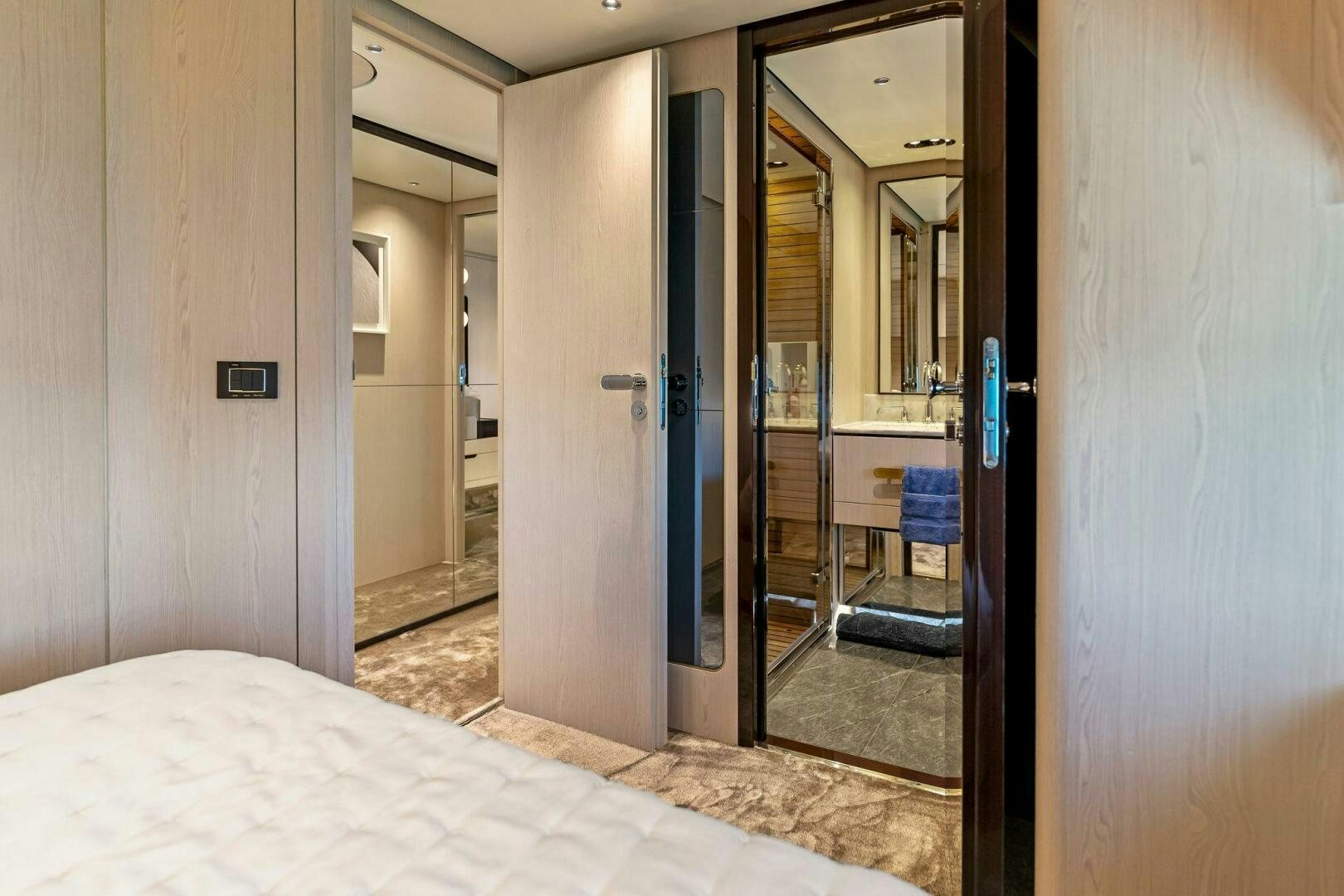 a bedroom with a glass door aboard LIMITLESS Yacht for Sale