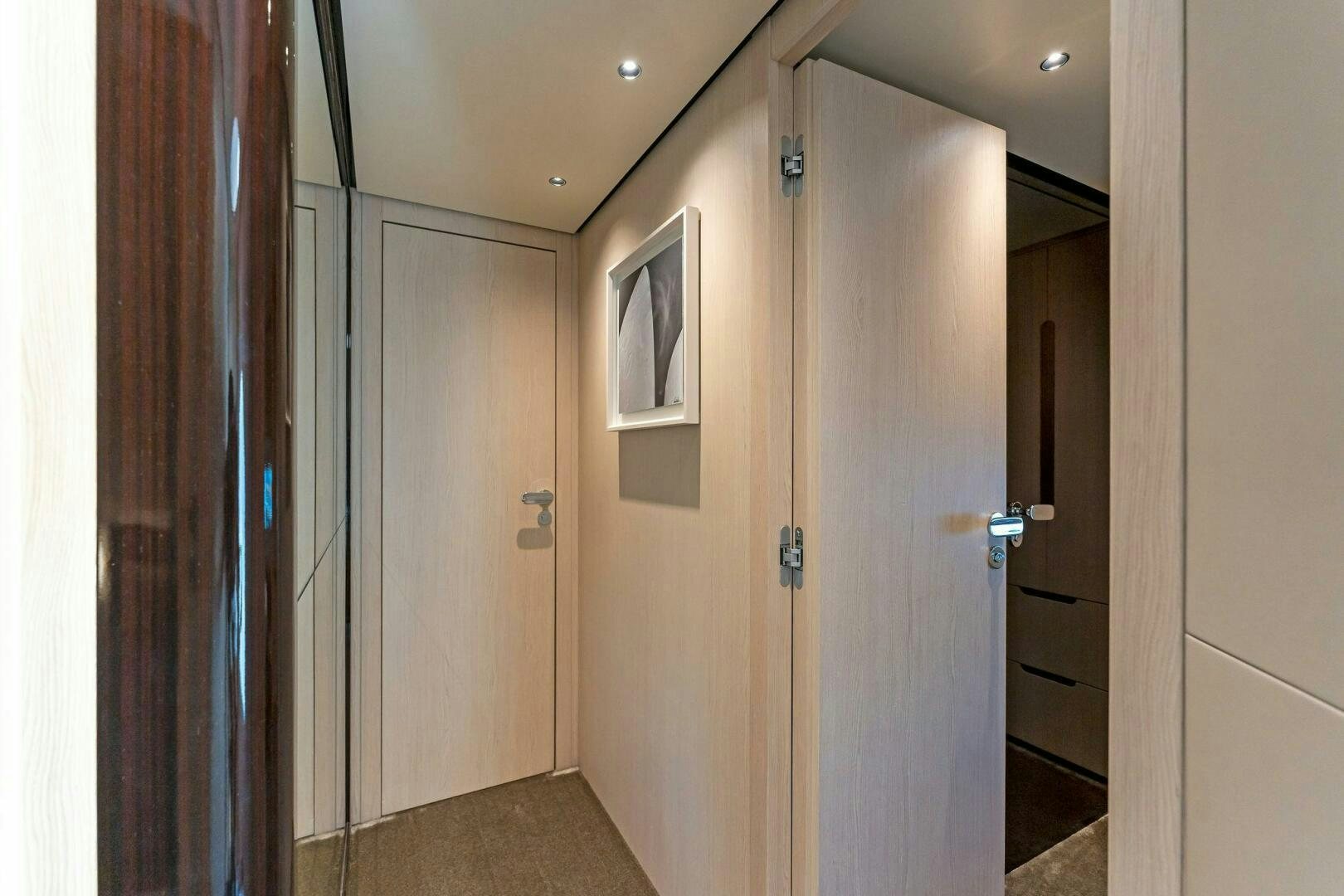a room with a door and a mirror aboard LIMITLESS Yacht for Sale