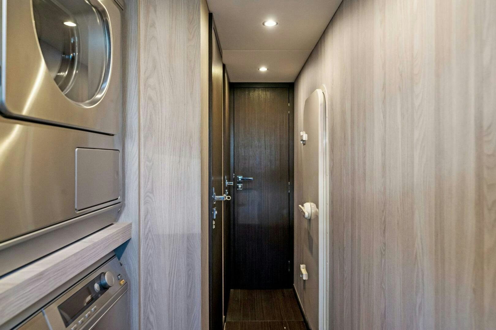 a room with a door and a mirror aboard LIMITLESS Yacht for Sale