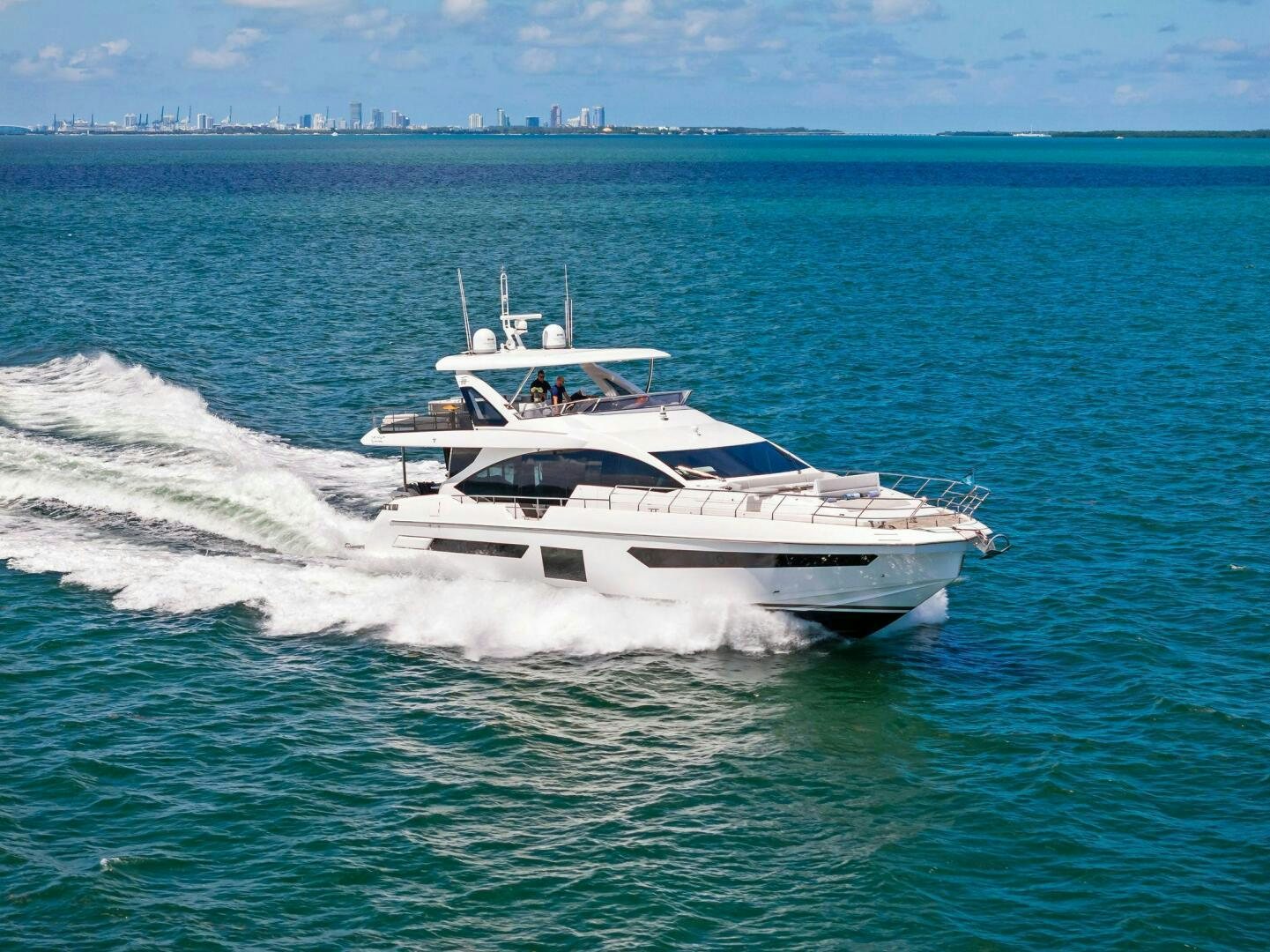 a white yacht on the water aboard LIMITLESS Yacht for Sale