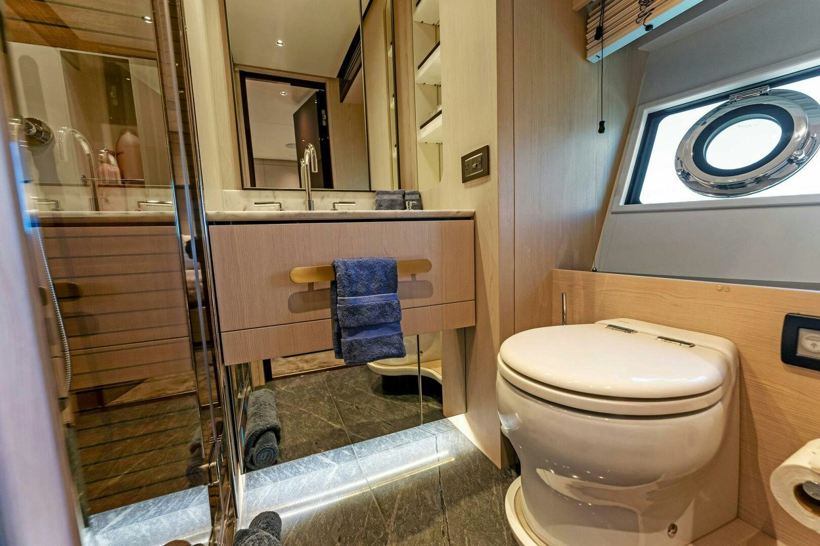a bathroom with a glass shower aboard LIMITLESS Yacht for Sale