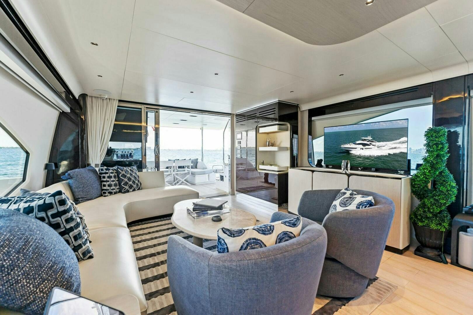 a living room with a large screen aboard LIMITLESS Yacht for Sale