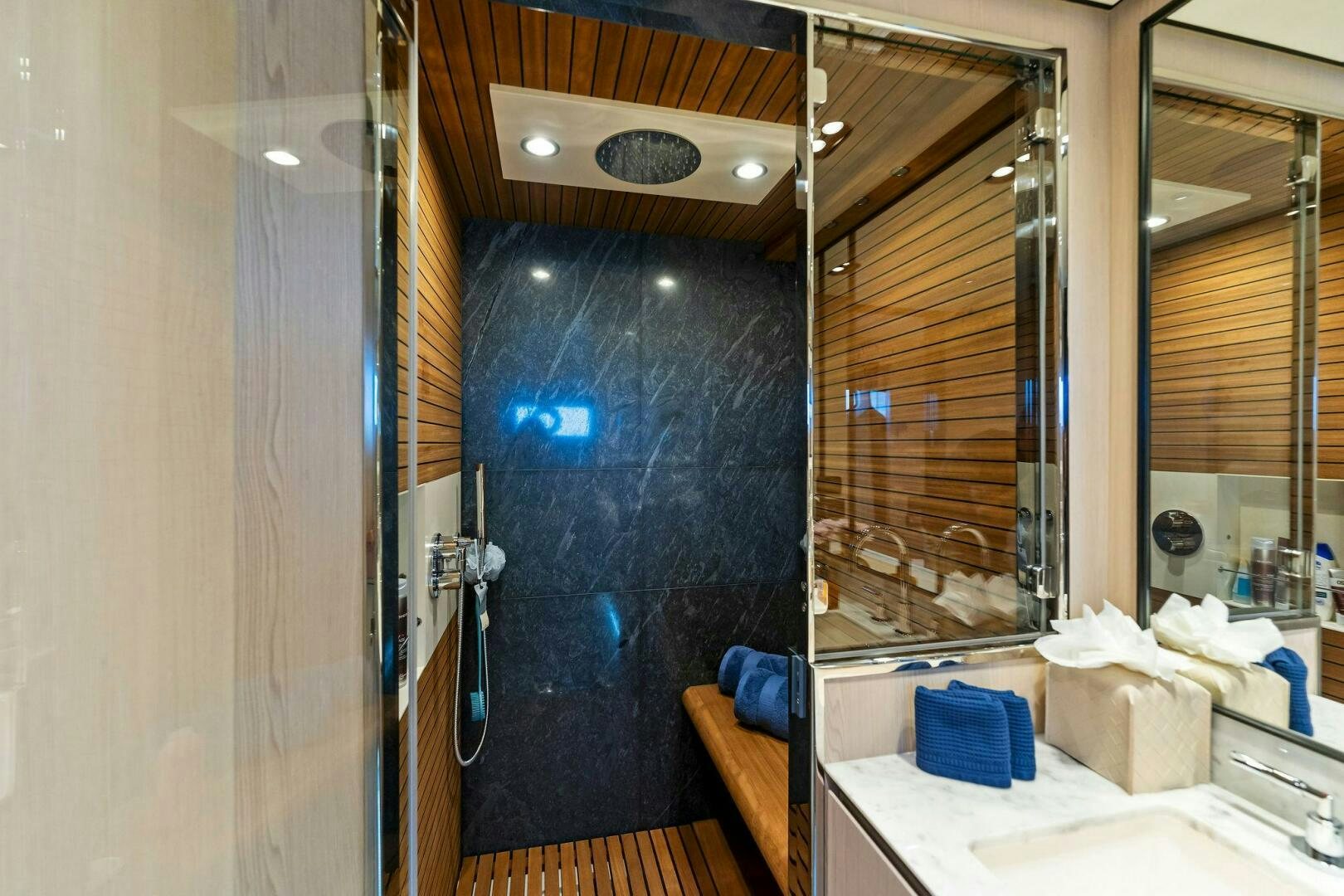 a bathroom with a shower and sink aboard LIMITLESS Yacht for Sale