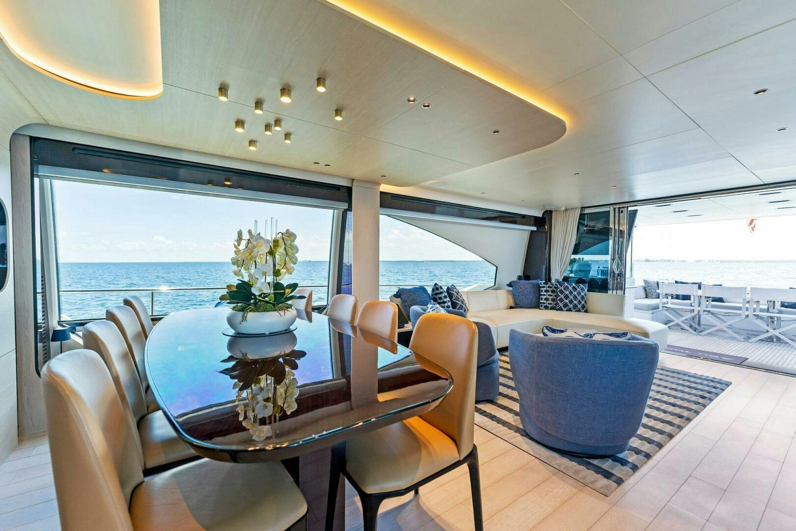 a dining room with a view of the ocean aboard LIMITLESS Yacht for Sale