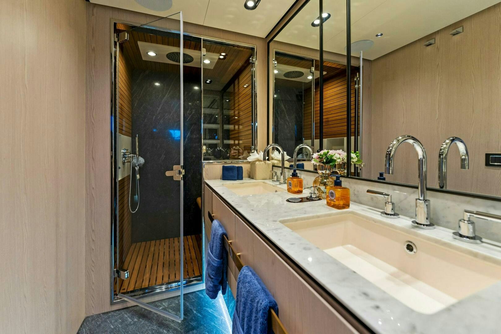 a bathroom with a large mirror aboard LIMITLESS Yacht for Sale