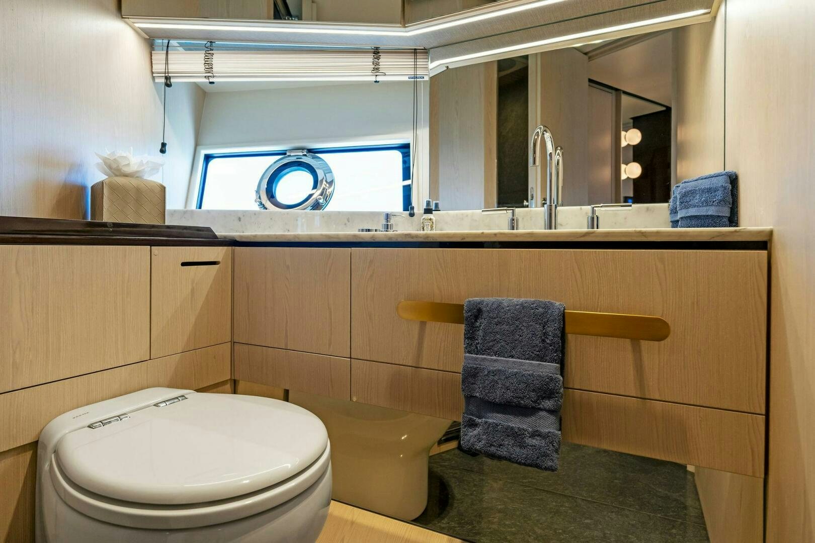 a bathroom with a sink and toilet aboard LIMITLESS Yacht for Sale
