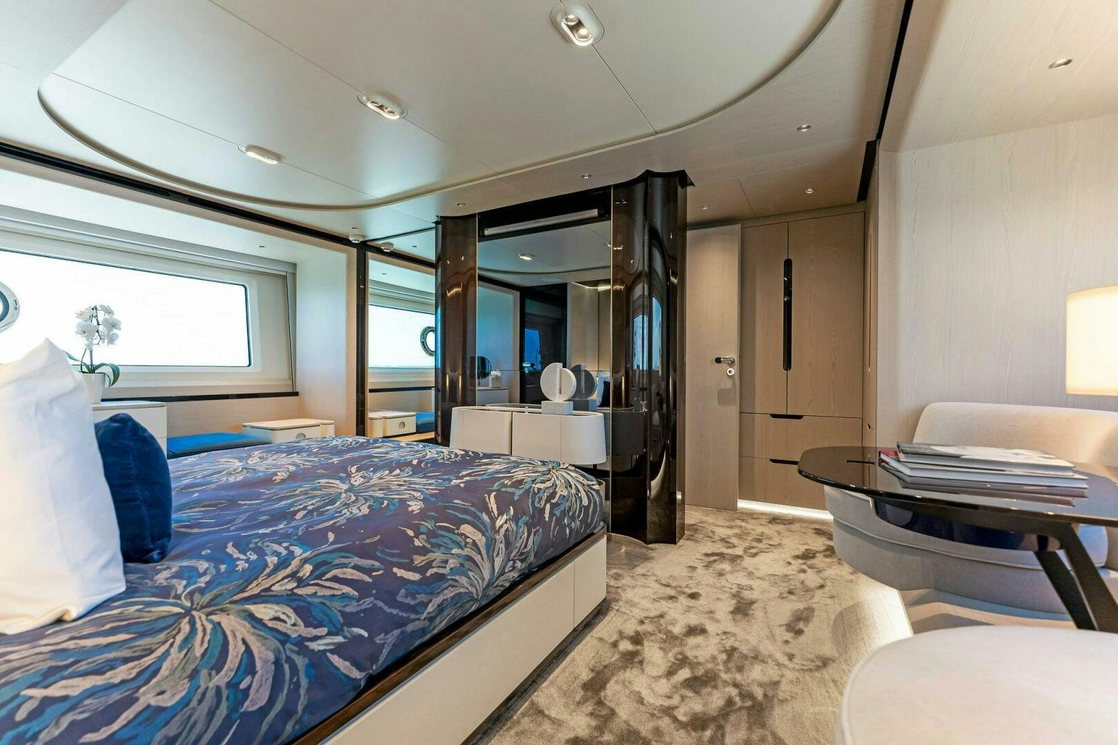 a room with a bed and a mirror aboard LIMITLESS Yacht for Sale