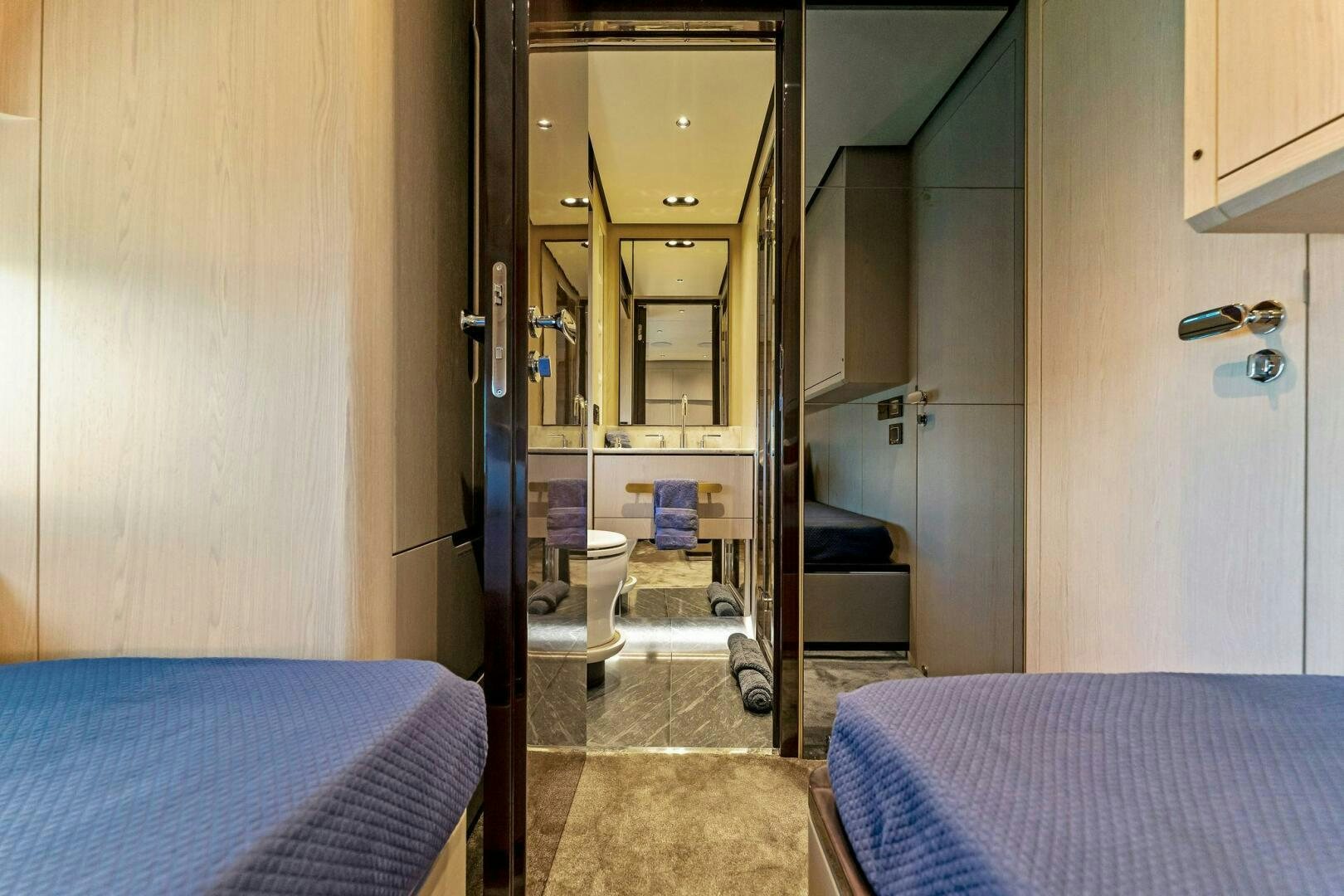 a room with a bed and a closet aboard LIMITLESS Yacht for Sale