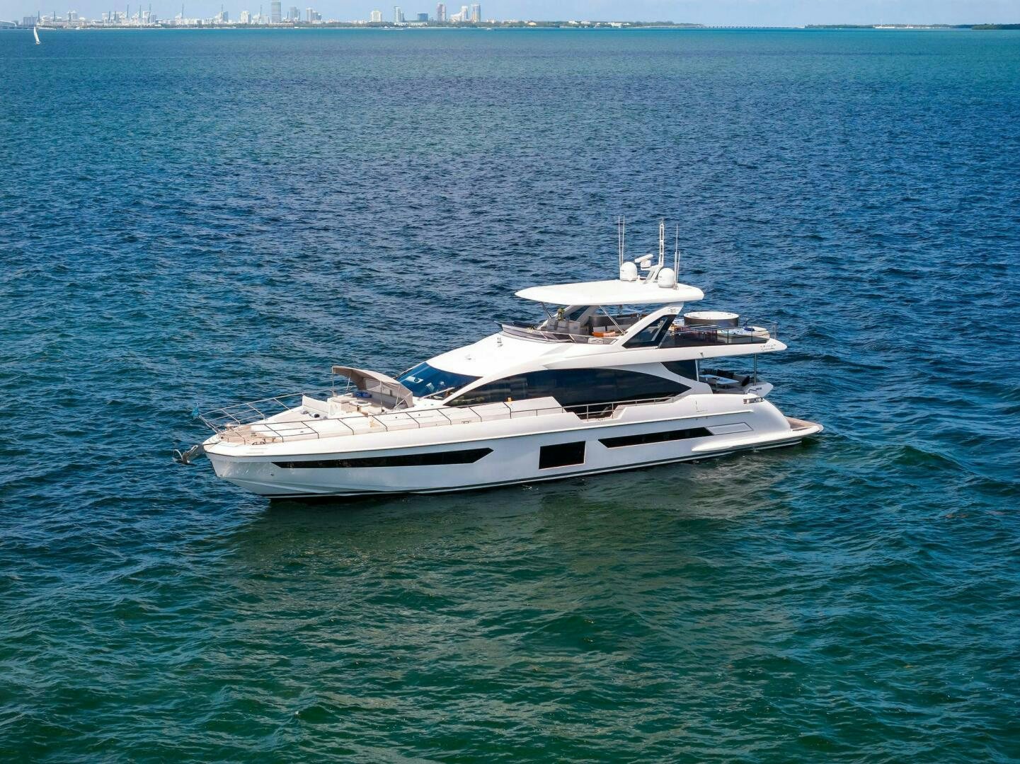 a white yacht in the water aboard LIMITLESS Yacht for Sale