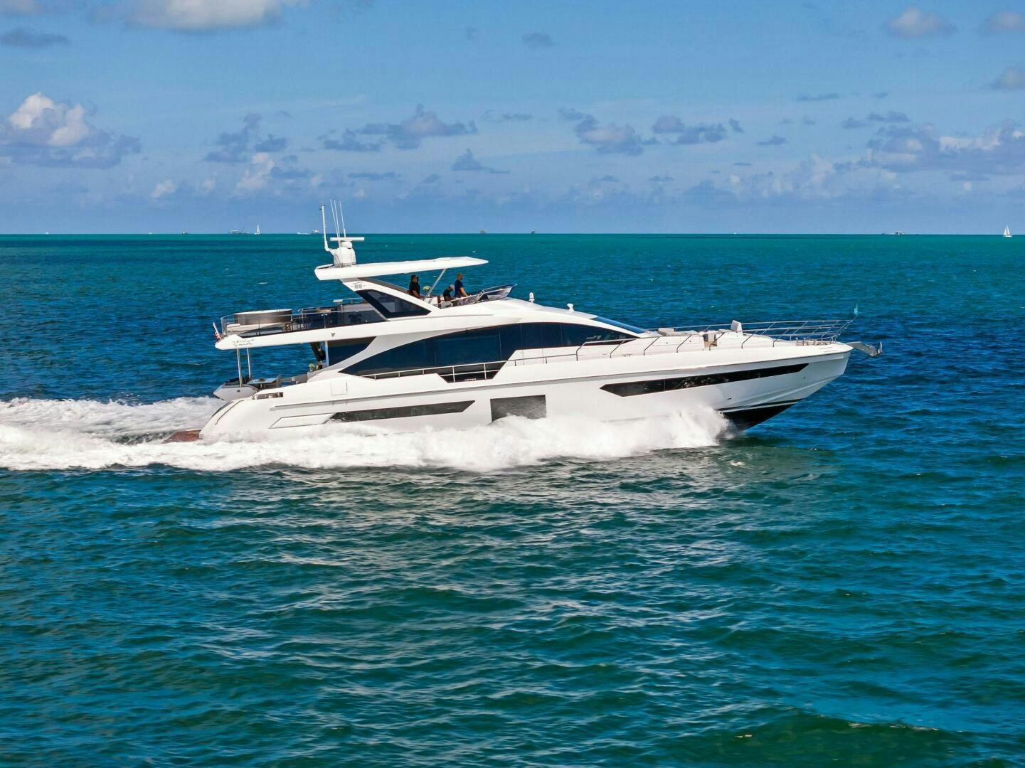 a white boat in the water aboard LIMITLESS Yacht for Sale