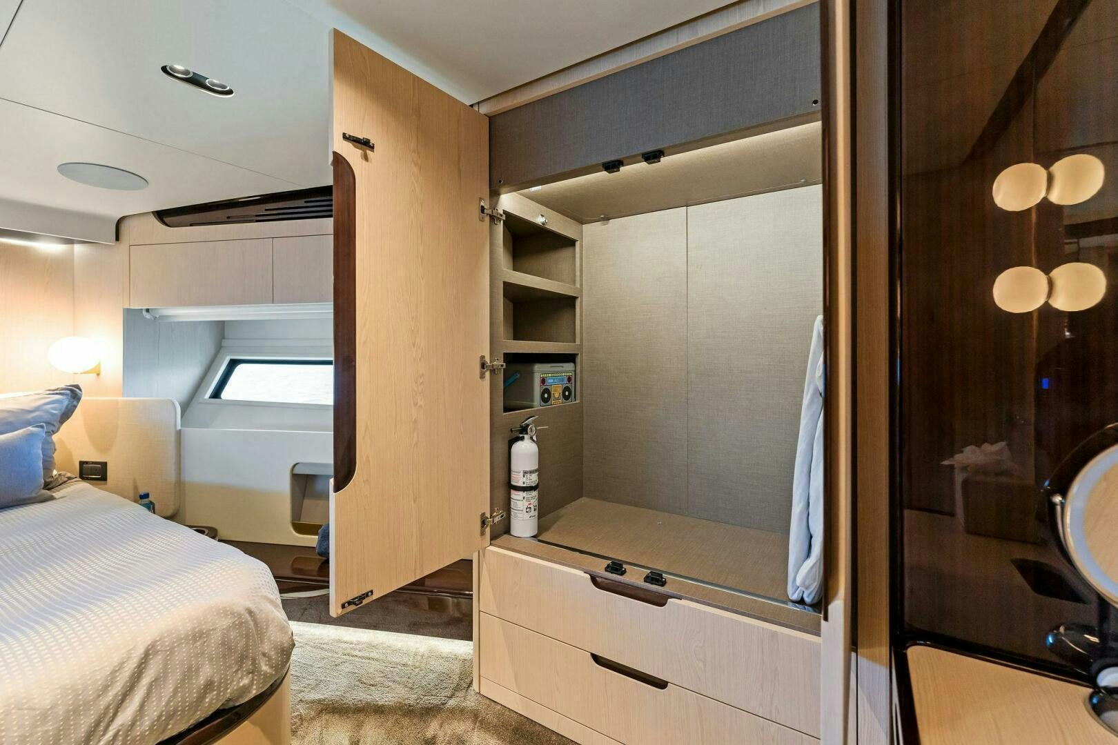 a room with a bed and a mirror aboard LIMITLESS Yacht for Sale