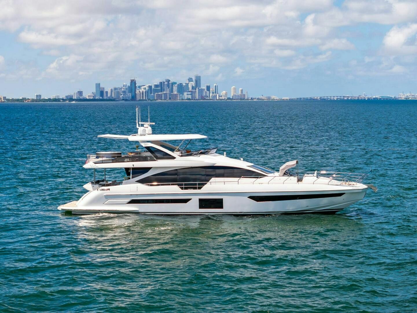 a white yacht in the water aboard LIMITLESS Yacht for Sale