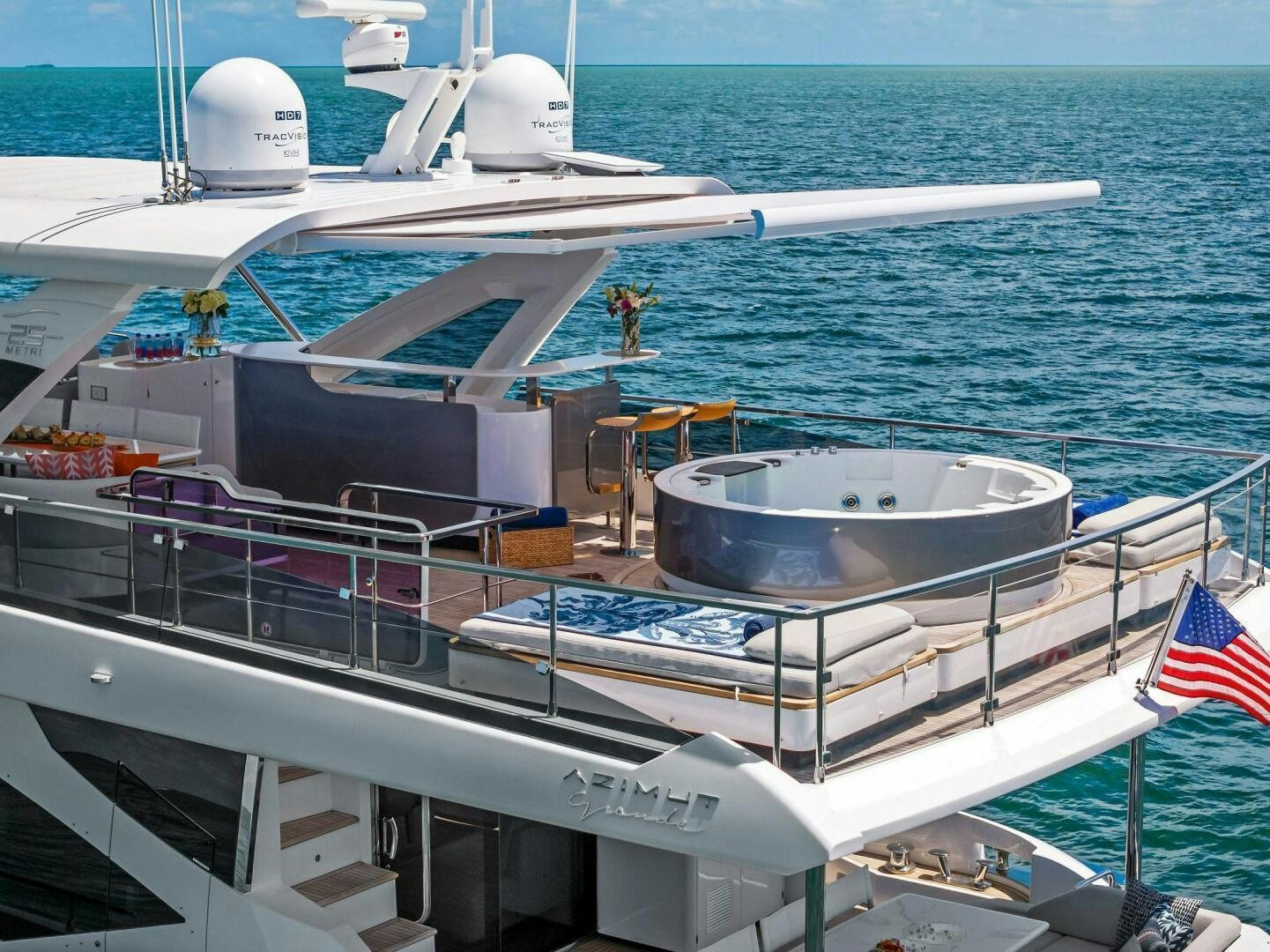 a boat with a flag on the deck aboard LIMITLESS Yacht for Sale