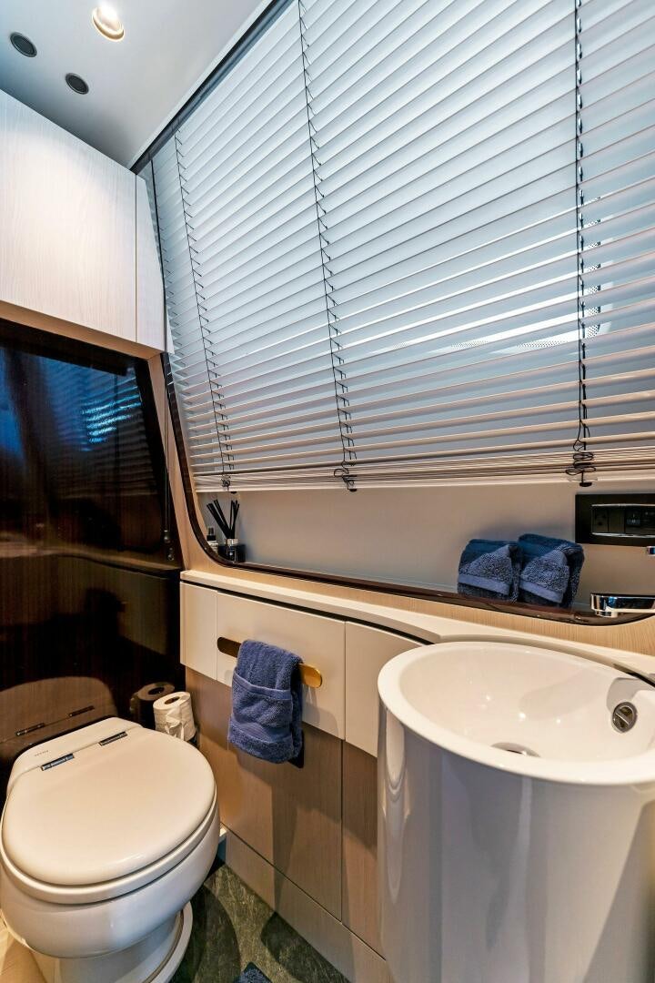 a bathroom with a sink and toilet aboard LIMITLESS Yacht for Sale
