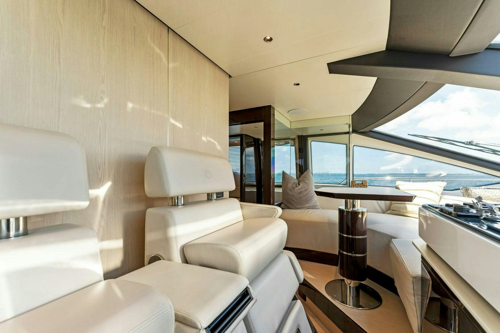 a room with a table and chairs aboard LIMITLESS Yacht for Sale