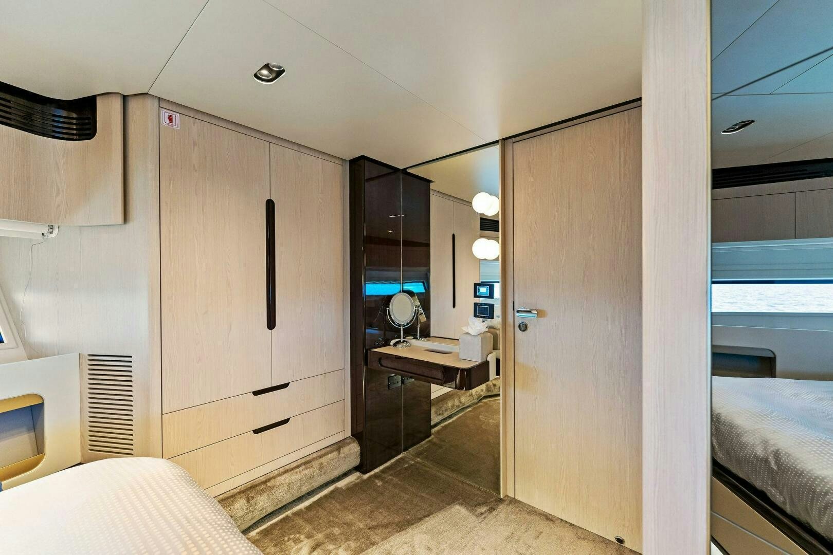 a room with a bed and a desk aboard LIMITLESS Yacht for Sale