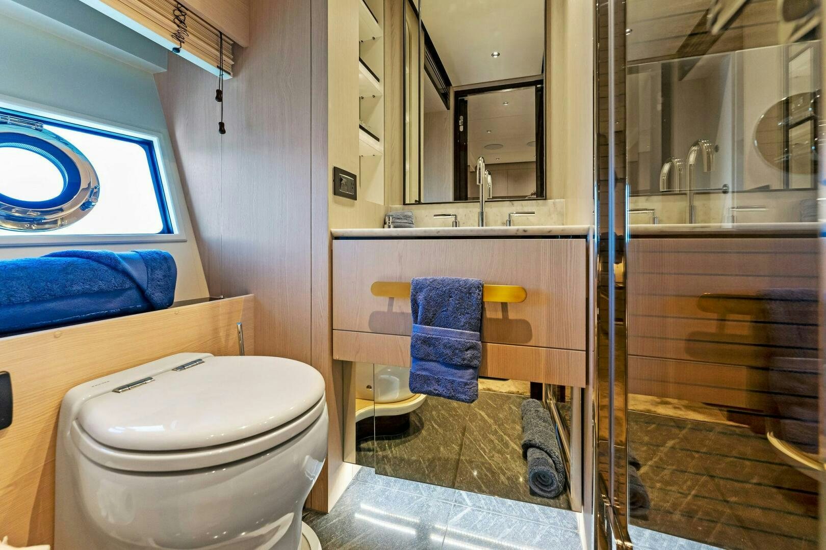 a bathroom with a glass shower aboard LIMITLESS Yacht for Sale