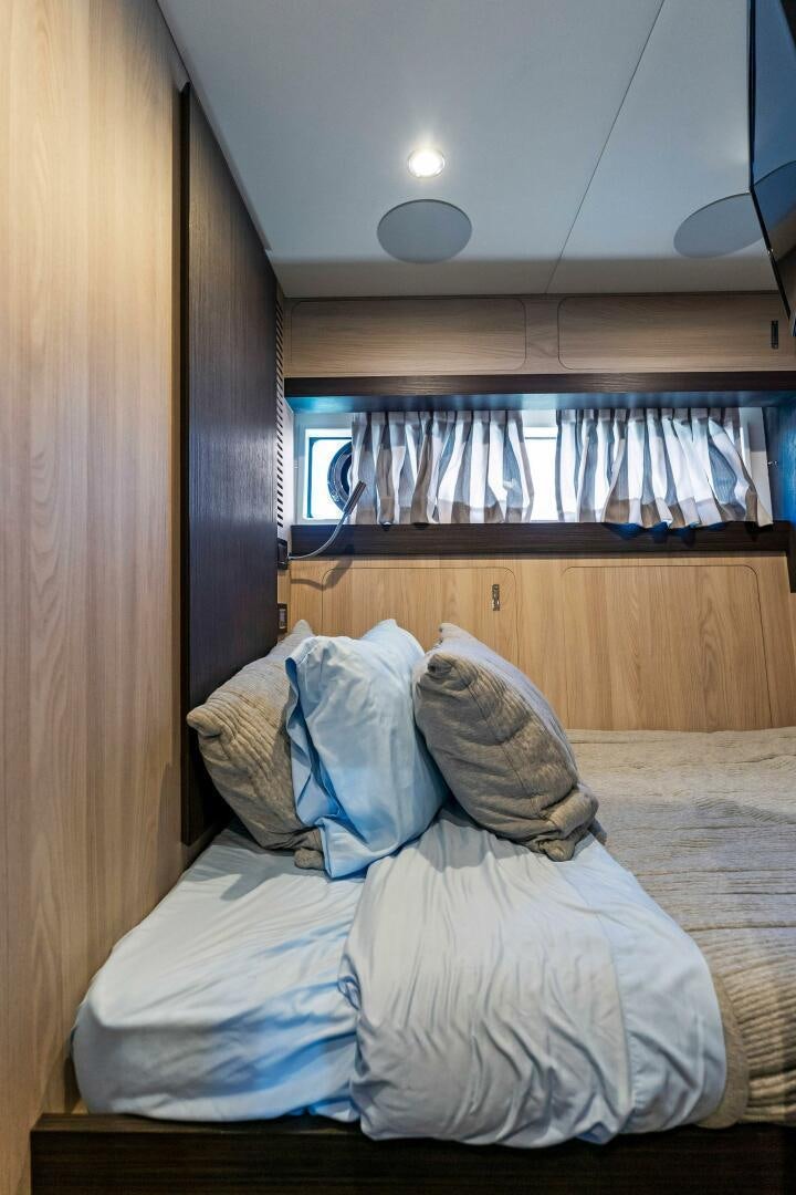 a room with a bed and a window aboard LIMITLESS Yacht for Sale