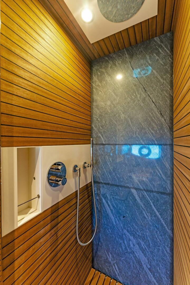 a blue shower curtain aboard LIMITLESS Yacht for Sale