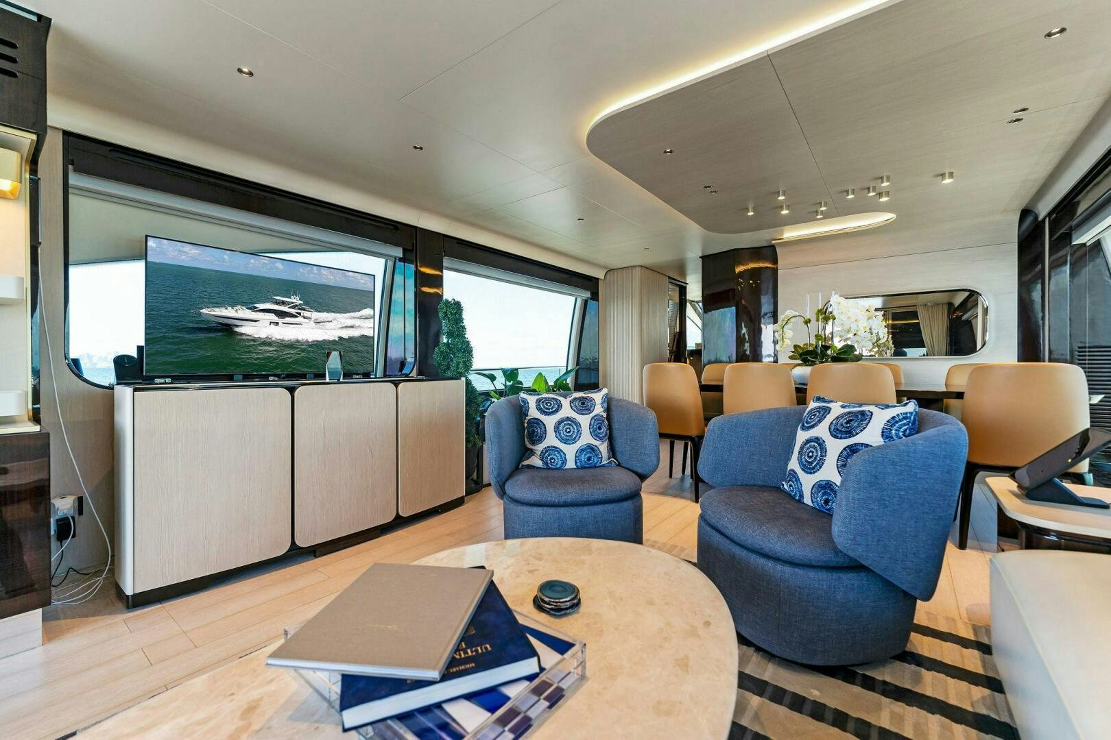 a living room with a large screen aboard LIMITLESS Yacht for Sale