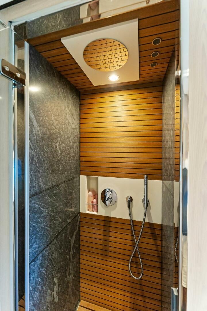 a wood cabinet with a mirror above it aboard LIMITLESS Yacht for Sale