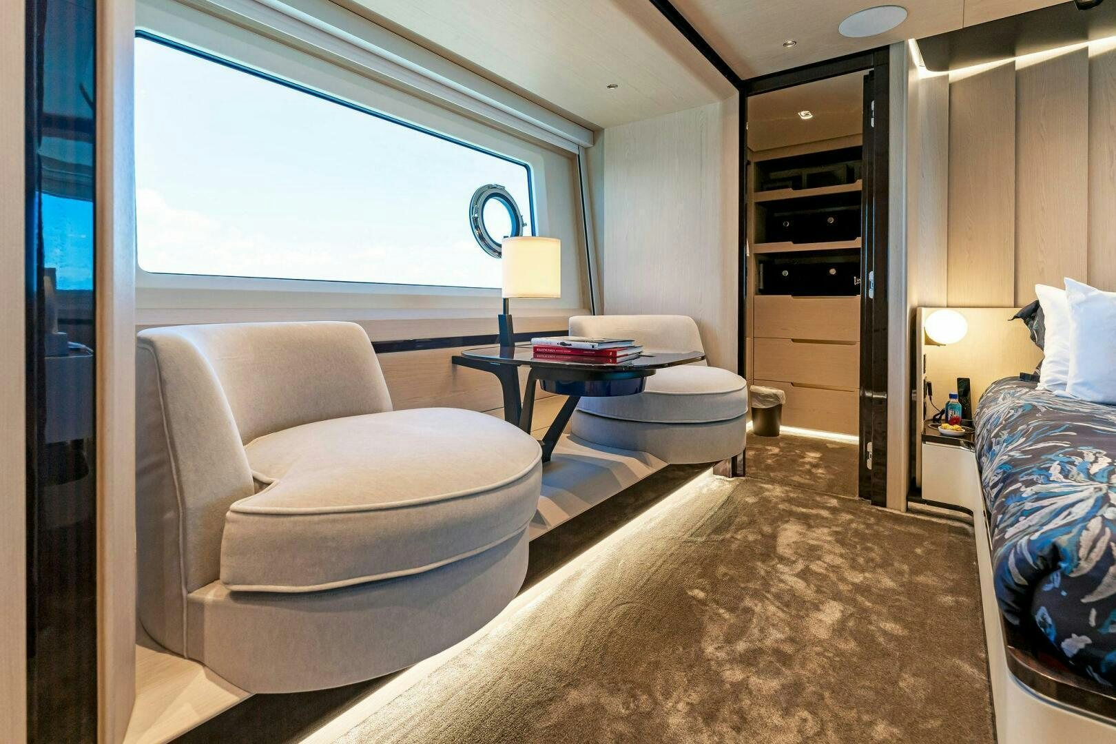 a room with a couch and a table and a bed aboard LIMITLESS Yacht for Sale
