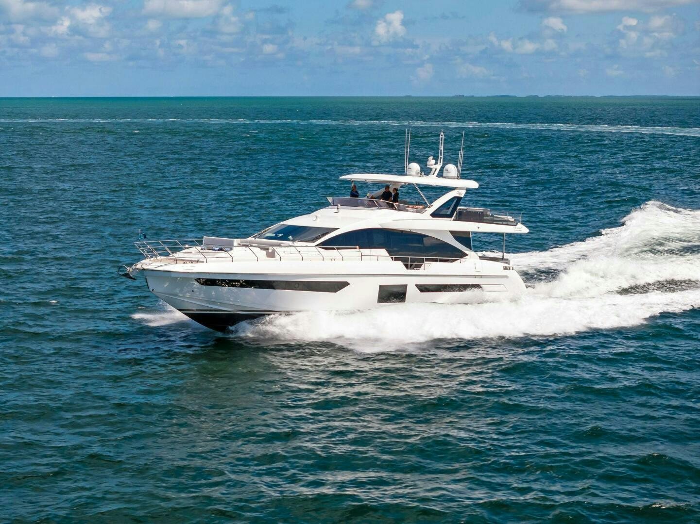 a white yacht in the water aboard LIMITLESS Yacht for Sale