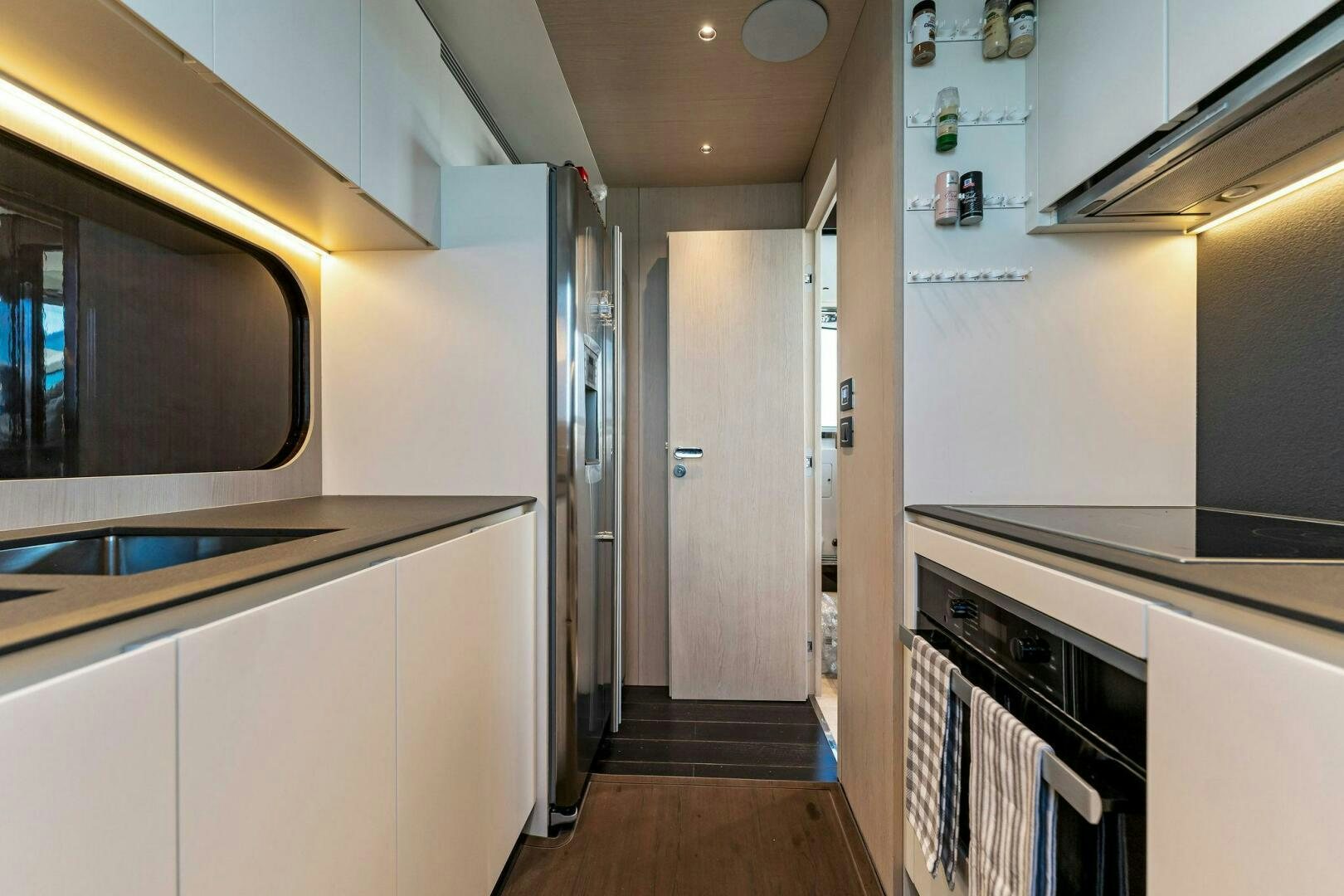 a kitchen with white cabinets aboard LIMITLESS Yacht for Sale